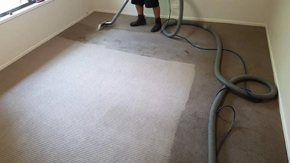 A room mid-clean, the cleaned area visibly brighter