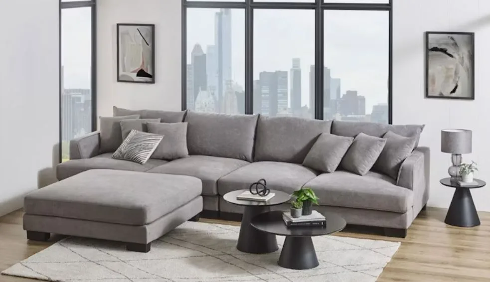 A grey fabric modular lounge in a bright living room